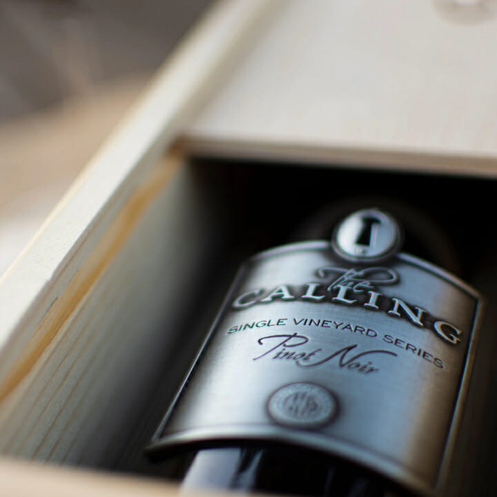 One of The Calling's Pinot Noirs resting in a box.